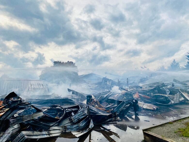 The remains of a charred building on a cloudy day.