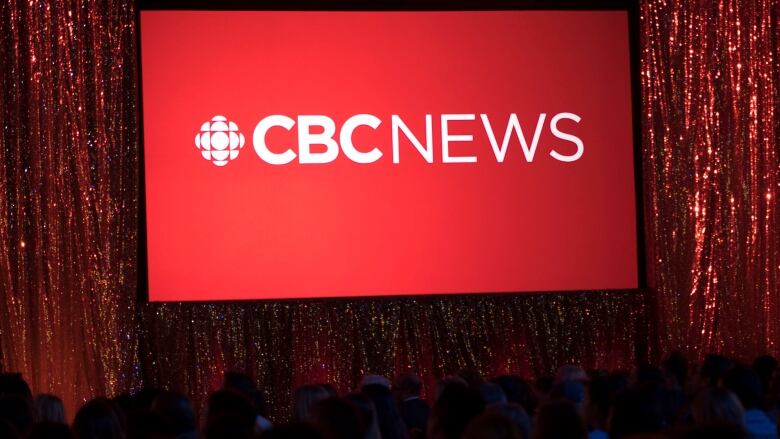 The CBC News logo is projected onto a screen.