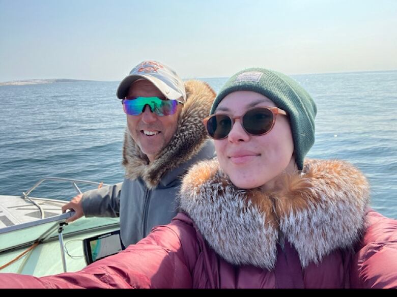 A man and a woman spend time on a boat