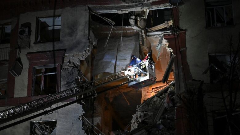 A rescuer works at a residential building that was damaged by a Russian missile strike,  in Zaporizhzhia, Ukraine.