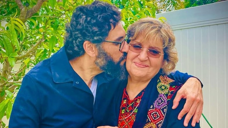 Ousama Alshurafa kissing his mother on the cheek in undated photo.