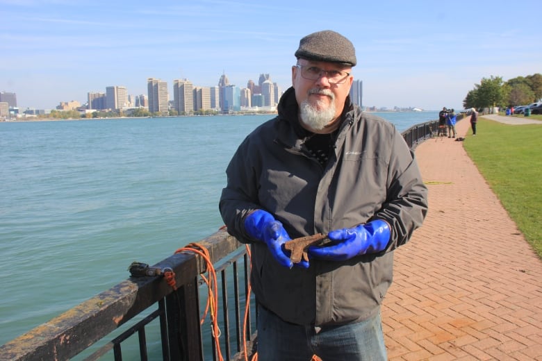 A man holds a small toy