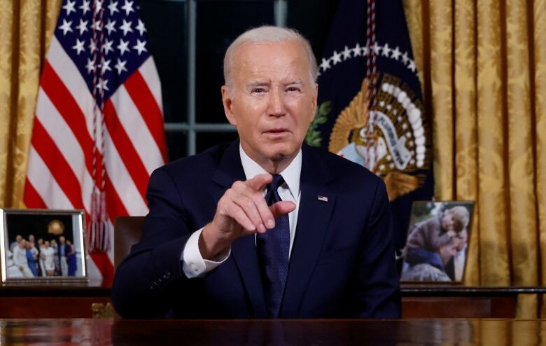 Biden at desk, pointing