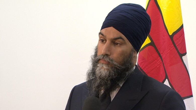 portrait of a man in front of a nunavut flag