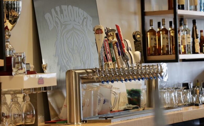 Beer taps, glassware and shelves of liquor at Dalhousie University's campus bar.