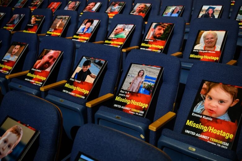 A stadium with photos of people displayed on the seats.