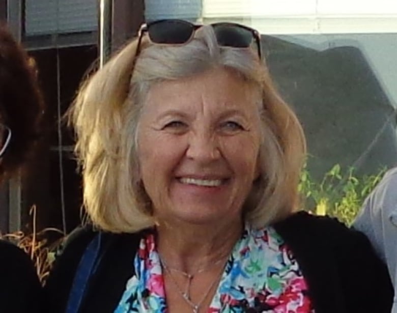 A headshot of a woman with blonde hair smiling for a photo.