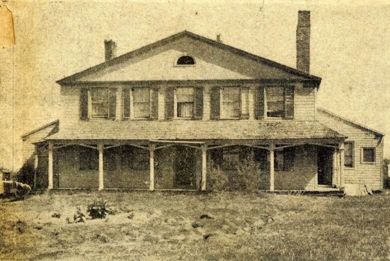 An archival black and white photo of the house