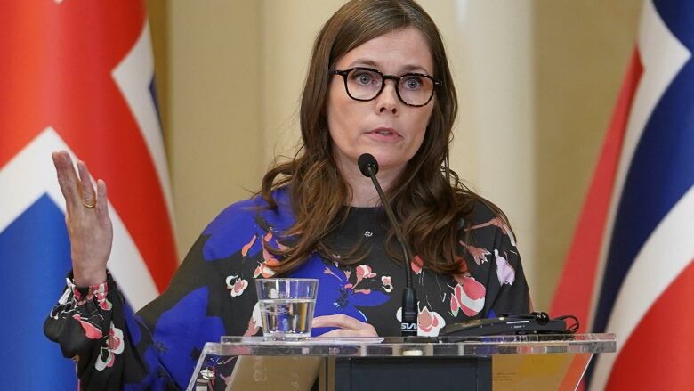 A woman speaks at a podium during a press conference.