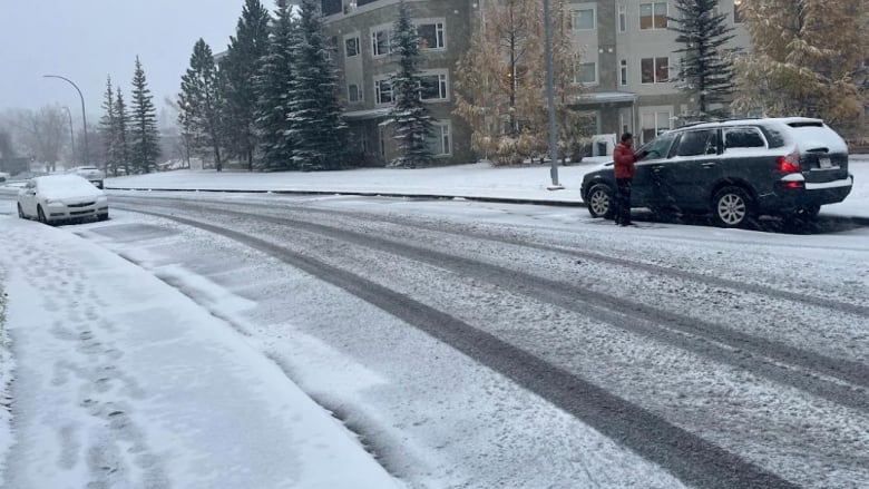 Two cars are pictured in the snow.