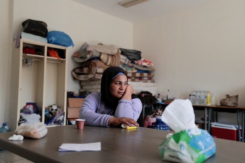 Zamzam, 33, who said she escaped from the south Lebanese village of Beit Lif near the Israeli border sits  at a school where she  takes refuge in Tyre, Lebanon October 20, 2023.