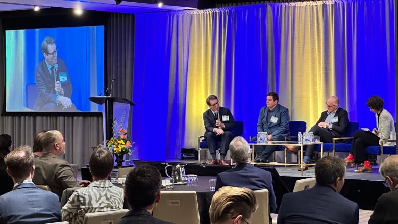 Evan Wilson, at left on stage, is with the Canadian Renewable Energy Association and Paul McLauchlin, 2nd from the left, is with the Rural Municipalities of Alberta. They were part of a panel discussion at the Pembina Institute's Alberta Climate Summit in Calgary on Thursday, Oct. 26, 2023. 