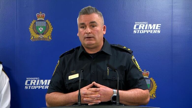 A police constable speaks at a news conference to reporters off-camera.