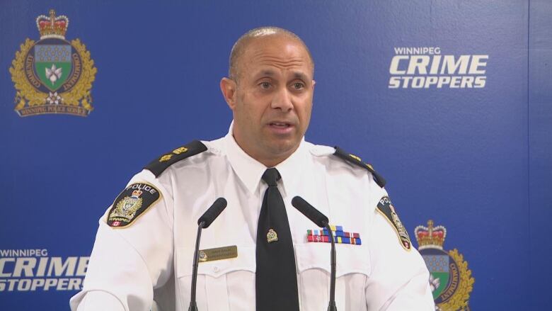 A police officer speaks to media during a news conference.