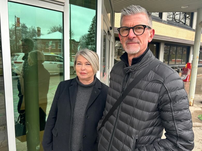 A man and a woman stand together outside Grace Hospital.