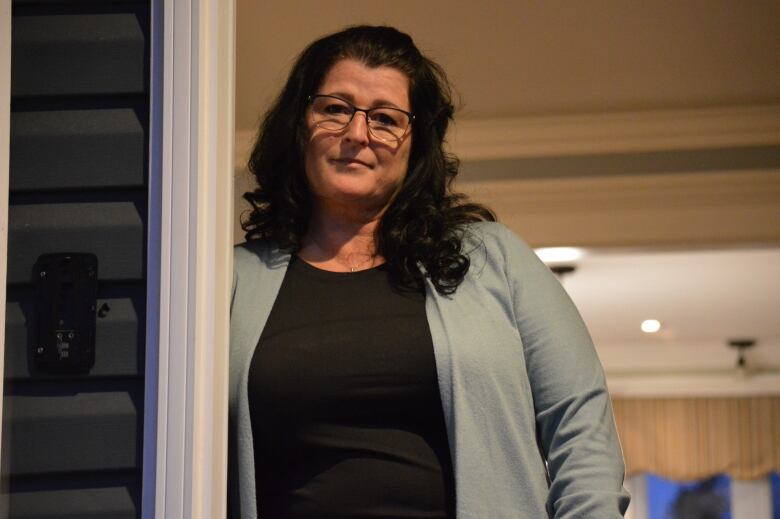 A woman stands in doorway