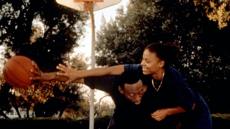 Omar Epps (left) and Sanaa Lathan (right) in a still from Love & Basketball. They're playing basketball outside.