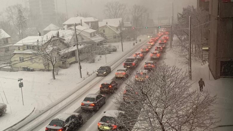 This picture shows backed up traffic and snowy roads.