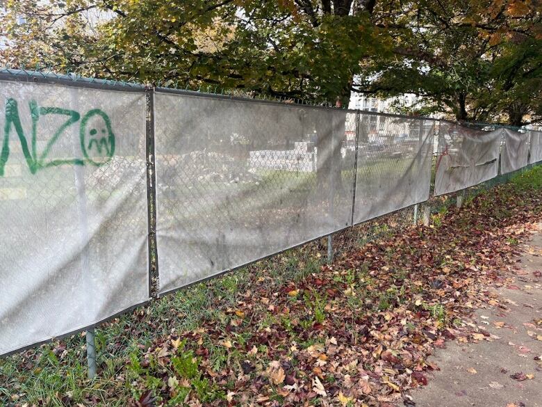 Signs about the Little Mountain development have been turned over on one side of the expansive property.