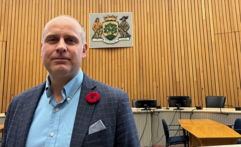 Coun. Stephen Holyday, who chairs Etobicooke's community council, says he wants a halt to the city's plan to scrap the Etobicoke coat of arms, until councillors have an opportunity to debate the issue.