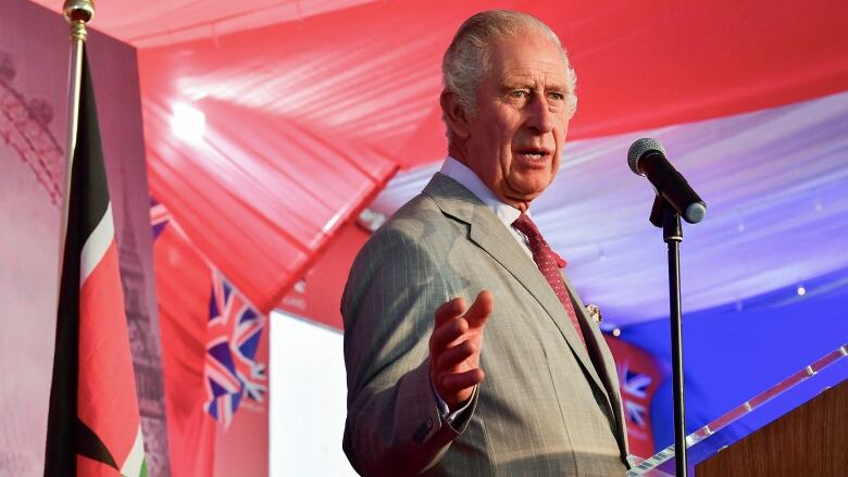 A person gestures while delivering a speech.