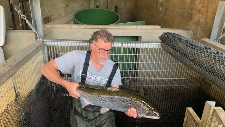 A man holds a fish