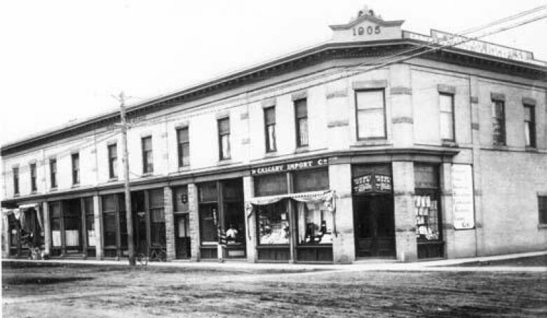 An older, black-and-white photo of a two-storey city building.