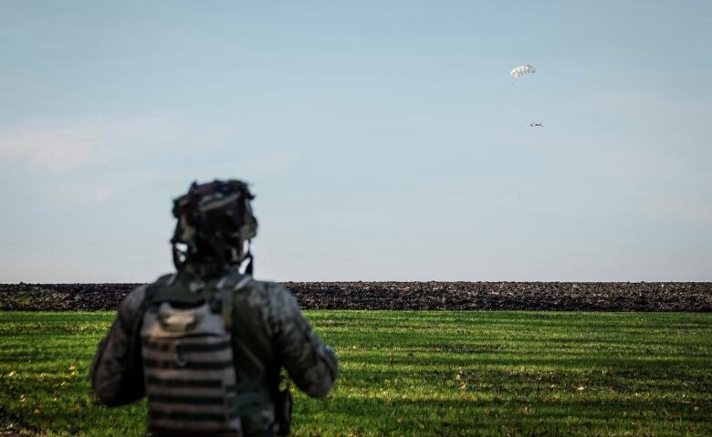 A Ukrainian soldier watches a drone landing in Ukraine's Kharkiv region.