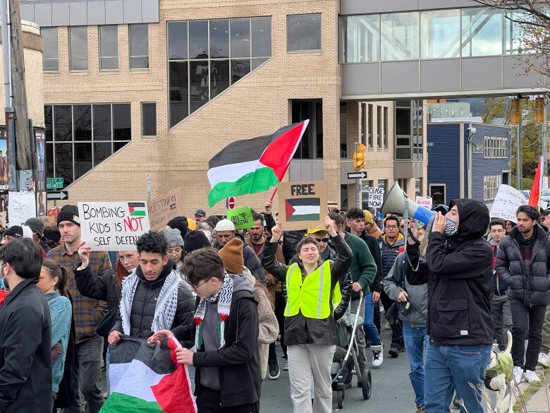 Protesters march in a large group.