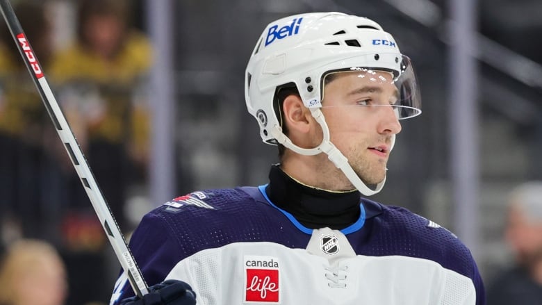 A hockey player wearing a neck guard. 