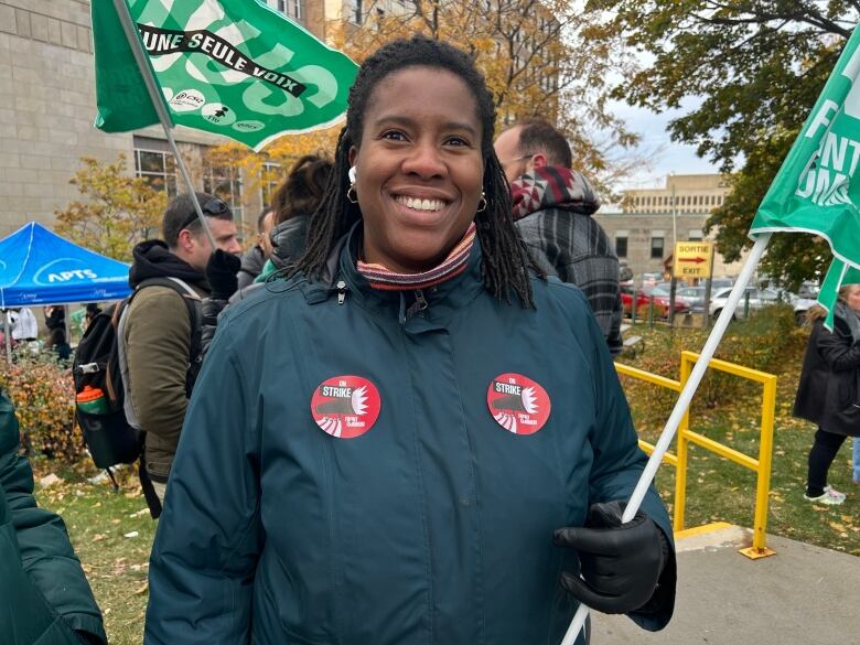 A woman holds a flag at a protest. 