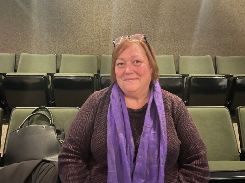 A woman sitting on chairs.