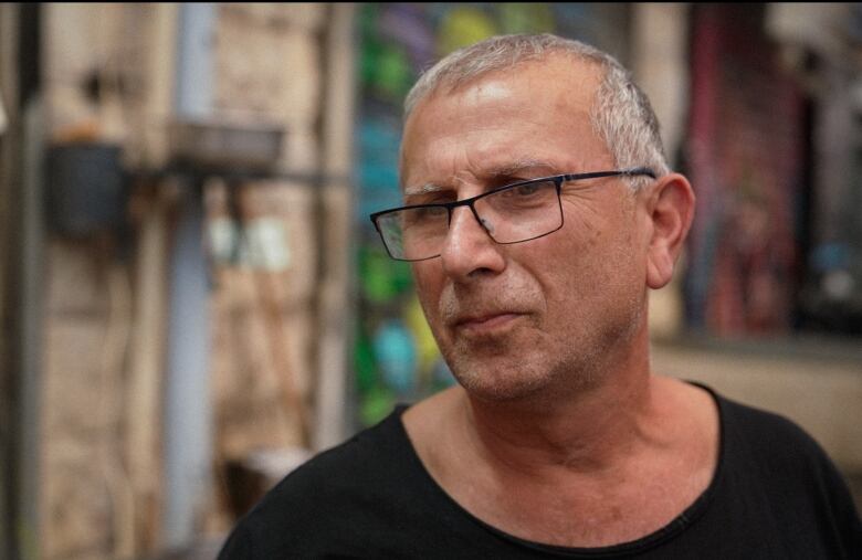 A man stands in a market.