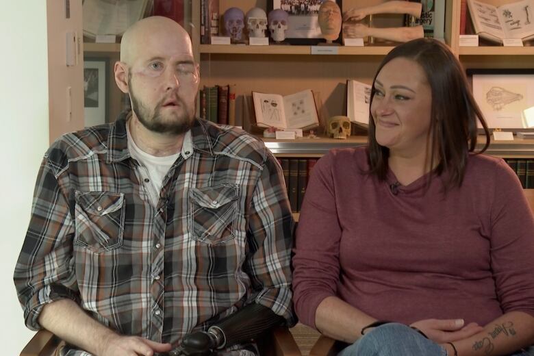 Aaron James speaks during an interview, accompanied by his wife, Meagan.