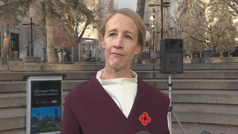 a blonde woman in a red coat