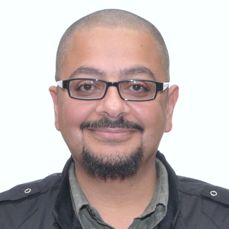 A head shot of a man smiling.