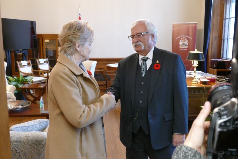 two people shake hands 