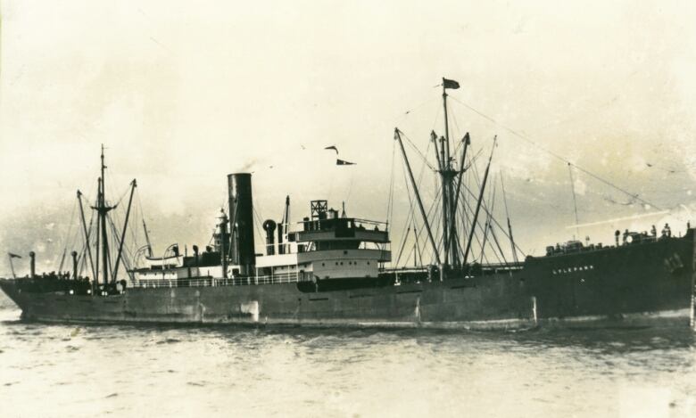 An old sepia-toned picture of a ship at sea.