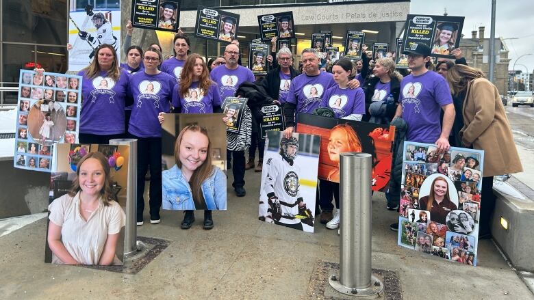 People in purple shirts stand together 