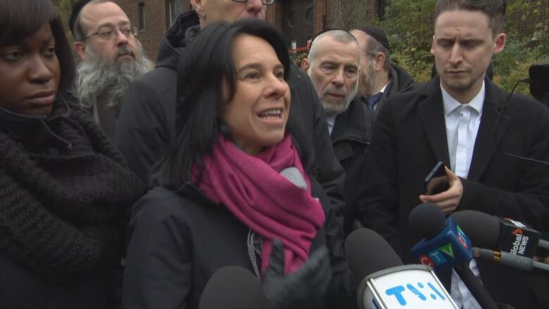 Valrie Plante speaks to reporters flanked by members of Montreal's Jewish community. 