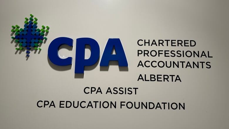 A sign and the CPA logo is shown on a white wall.