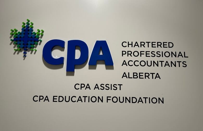 A sign and the CPA logo is shown on a white wall.