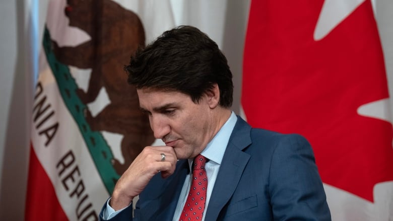 Prime Minister Justin Trudeau listens as California Governor Gavin Newsom delivers remarks