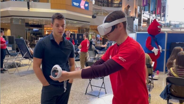 man in red shirt wearing VR headset