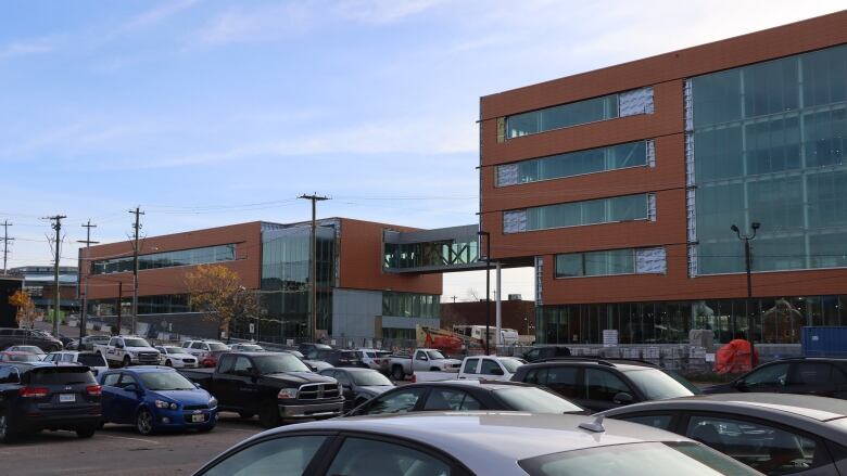 Cars parked next to the under construction NSCC Waterfront Campus. 