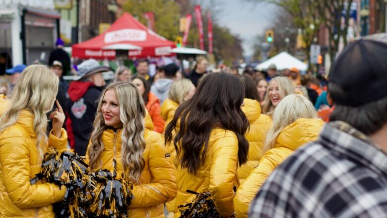 Members of the Hamilton Tiger-Cats cheer team take a walk down James Street North in Hamilton during Grey Cup week festivities on Nov. 17, 2023.