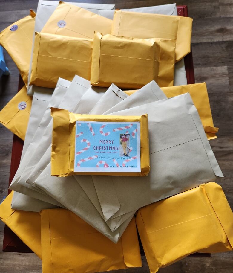 A pile of large brown and yellow envelopes. The top one has a card on the front that says Merry Christmas.