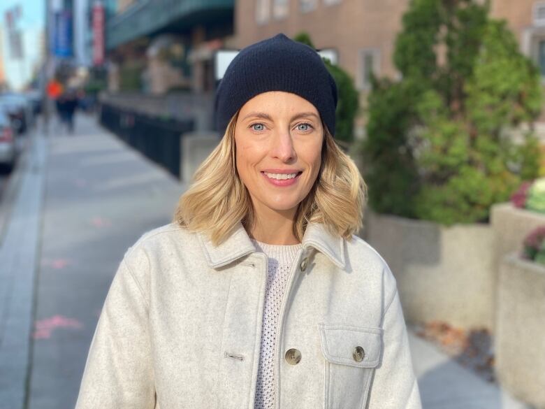 A woman looking at a camera in downtown Toronto.