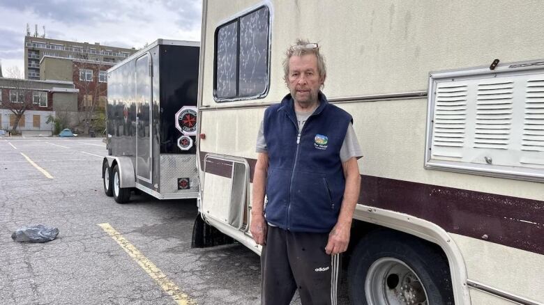 A man standing on a parking lot.