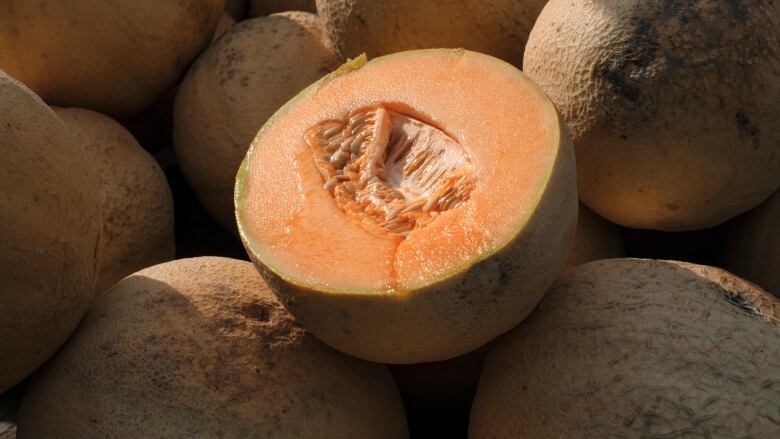 Cantaloupes including one cut in half.